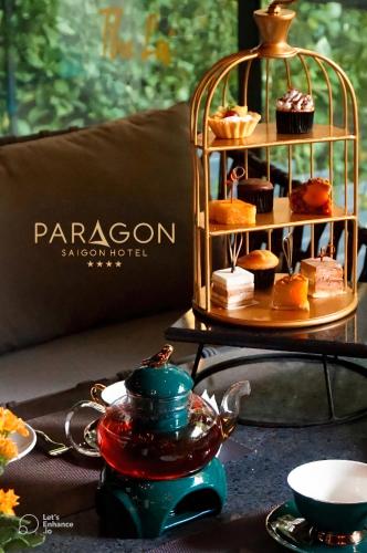 a table with a plate of pastries on a stand at Paragon Saigon Hotel in Ho Chi Minh City