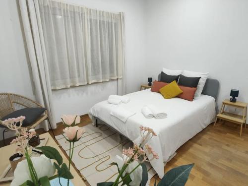 a bedroom with a white bed and a window at Sweet Little Orange in Lisbon