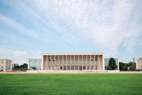 a large building with a grass field in front of it at Sweet Little Orange in Lisbon
