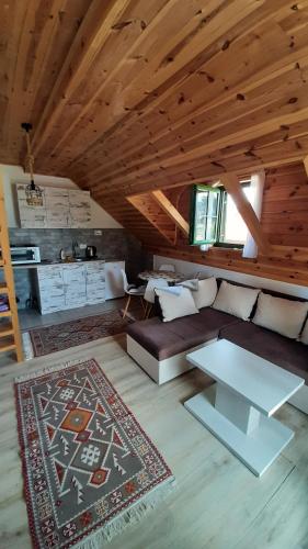 uma sala de estar com um sofá e uma mesa em Apartments Durmitor em Žabljak