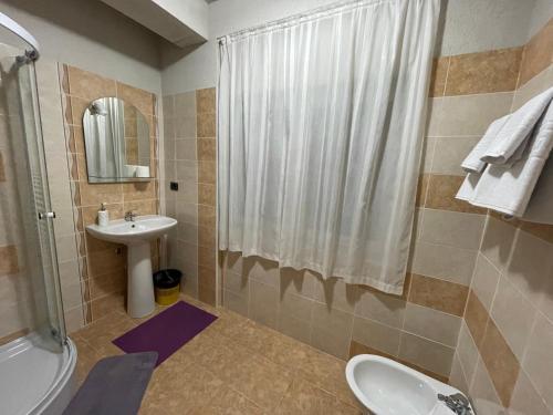 a bathroom with a sink and a toilet and a shower at River Side in Statiunea Borsa