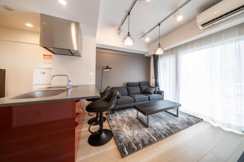 a kitchen and a living room with a couch at Creazione Akasaka in Tokyo