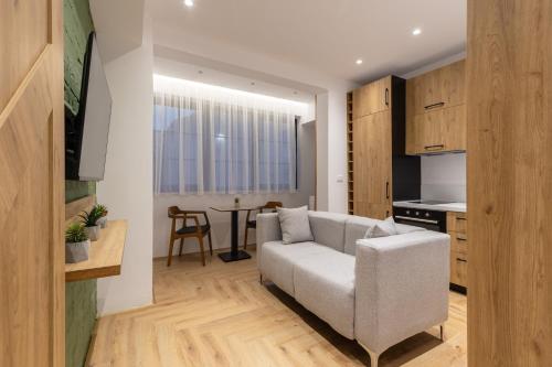 a living room with a couch and a table at Vatër Apartments in Tirana
