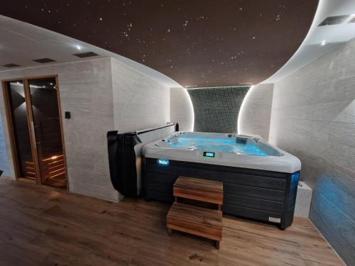 a bathroom with a jacuzzi tub in a room at BudinSKI Apartmány & Wellness in Liptovský Mikuláš