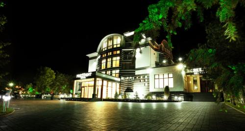 a building lit up at night at President Resort Hotel in Chişinău