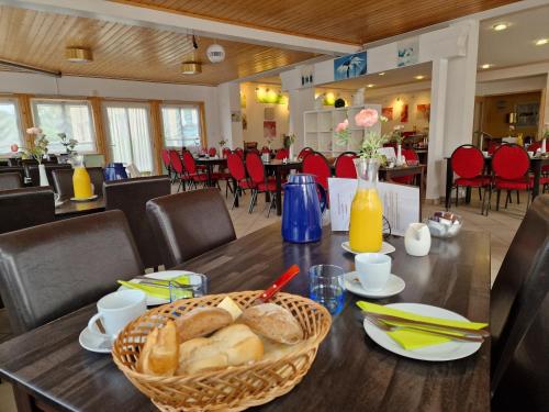 a table with a basket of bread on top of it at Spreewaldhotel Seerose in Burg