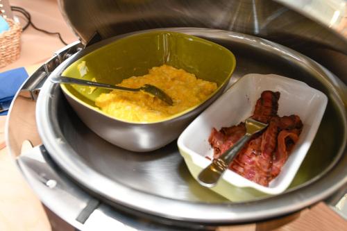 a plate with a bowl of food and a bowl of food at Hotel Aurora in Desenzano del Garda