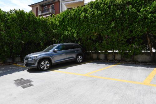 a silver car parked in a parking lot at Hotel Aurora in Desenzano del Garda