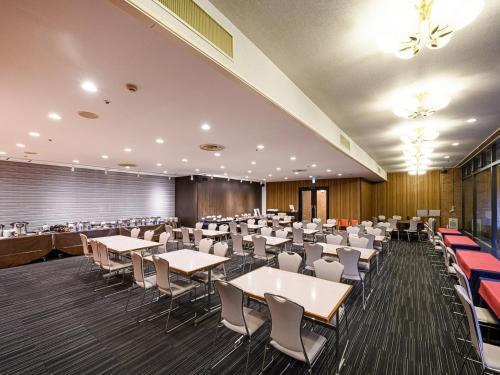 a large banquet hall with tables and chairs at APA Hotel Sapporo Odori Ekimae Minami in Sapporo