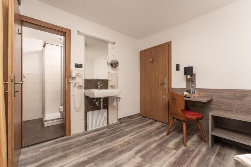 a bathroom with a sink and a desk and a chair at Alpenliebe in Sölden