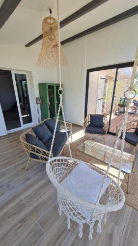 a living room with a swing and a couch at Maison l’Eucalyptus in Chauzon