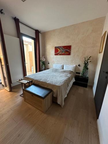 a bedroom with a large bed and a large window at L’Egyptienne in Antibes