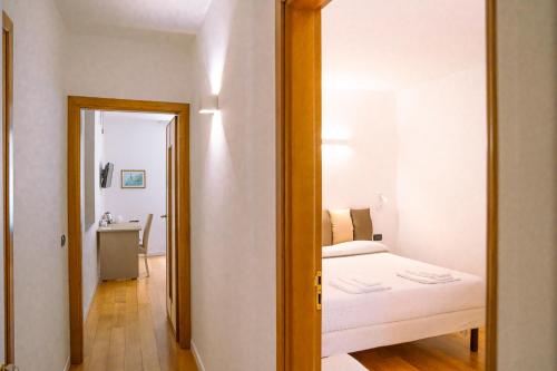 a small bedroom with a bed and a mirror at Residenza Ester in Amalfi