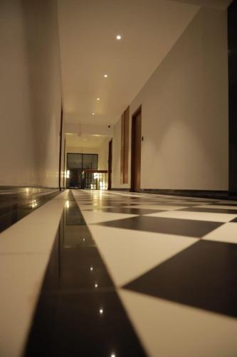an empty room with a black and white tile floor at ARUNACHALA INN in Kanyakumari