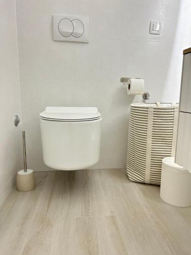 a bathroom with a toilet and a roll of toilet paper at Aurus 2 in Korčula