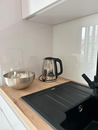 a tea kettle and a bowl on a counter in a kitchen at Aurus 2 in Korčula