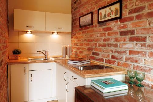 a kitchen with a brick wall and a sink at Oasis Resort & Spa in Rewal