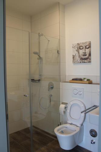 a bathroom with a glass shower with a toilet at Ferienwohnung Wiesflecken in Balingen