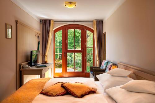 a bedroom with two beds in front of a window at Oasis Resort & Spa in Rewal