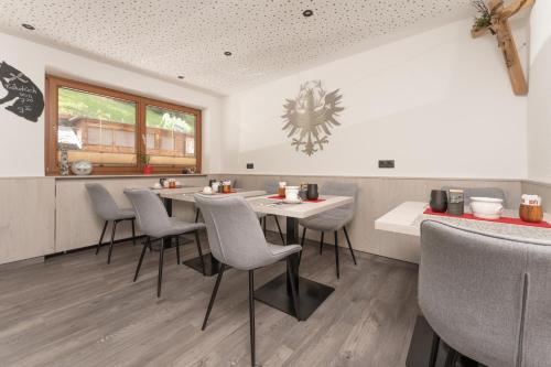 a restaurant with a table and chairs in a room at Alpenliebe in Sölden