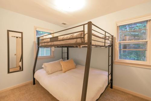 a bedroom with two bunk beds and a mirror at Galena Getaway Dog Friendly Frisco Retreat in Frisco
