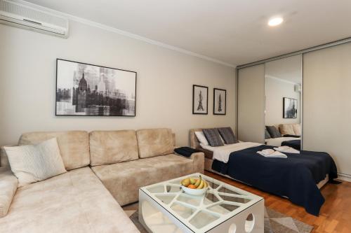 uma sala de estar com um sofá e uma cama em New Belgrade Apartments, parking 5 eur per day em Belgrado