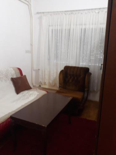 a bedroom with a couch and a window at Kovcic in Tuzla