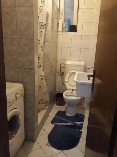 a small bathroom with a toilet and a sink at Kovcic in Tuzla