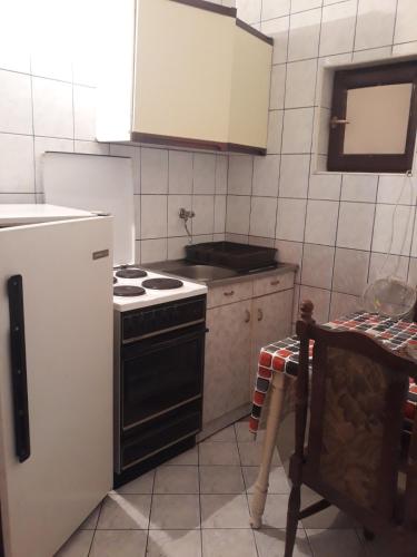 a kitchen with a stove and a refrigerator at Kovcic in Tuzla
