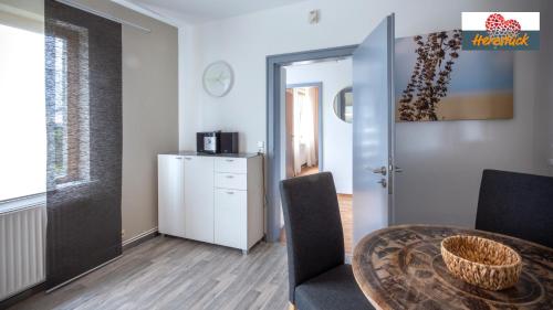 a room with a table and chairs and a door at Das Nest am Park in Lemgo