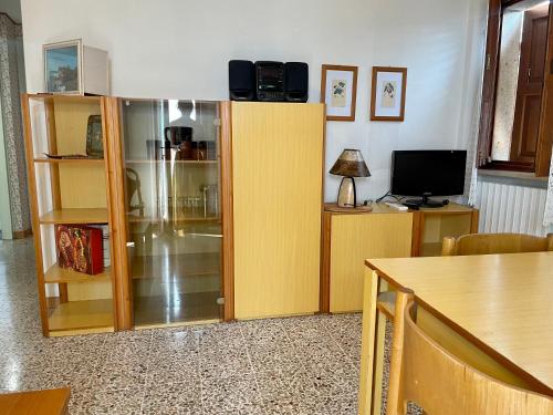 a living room with a yellow cabinet and a television at Apartment Vista Lake Torri in Torri del Benaco