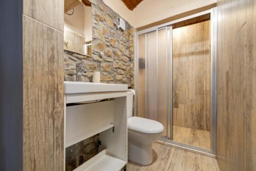 a bathroom with a white toilet and a shower at Aral Tatil Ciftligi in Bozcaada