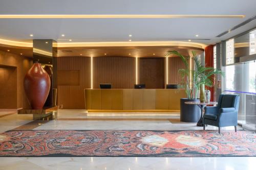 a lobby of a hotel with a reception desk at Hotel Coimbra Aeminium, Affiliated by Meliá in Coimbra