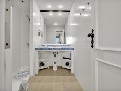 a large white bathroom with a sink and a mirror at 212 Elegant, renovated, confortable Playa Paraiso in Playa Paraiso