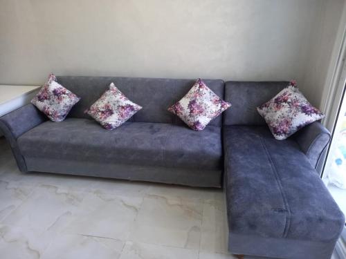 a couch with four pillows on it in a living room at Porto golf marina in El Alamein