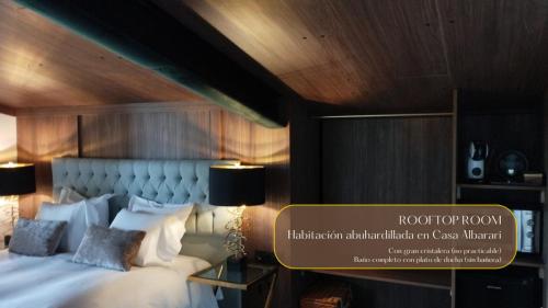 una habitación de hotel con una cama con un cartel. en Casa Albarari Boutique Double Rooms with access to shared Infinity Pool, en Sanxenxo