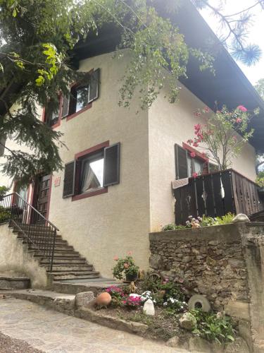 a house with stairs and flowers in front of it at Haus Käfersberg in Naturno