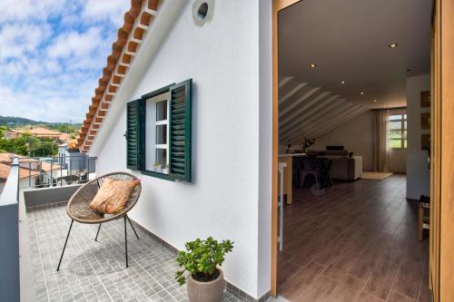 a view from the balcony of a house with a chair at Casa da Olides - T3 and Studio in Santana