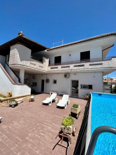 a patio with a swimming pool in front of a house at Case vacanze LULU in Seclì