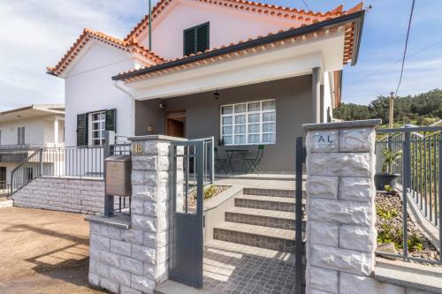 a house with a gate in front of it at Casa da Olides - T3 and Studio in Santana