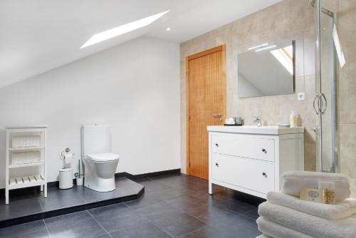 a bathroom with a sink and a toilet and a mirror at Casa da Olides - Studio in Santana