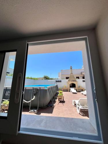 a view of a patio through a window at Case vacanze LULU in Seclì