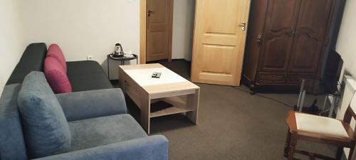 a living room with a couch and a table at Hotel Perfect in Varna City