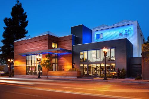 a building on a city street at night at Aloft Sunnyvale in Sunnyvale