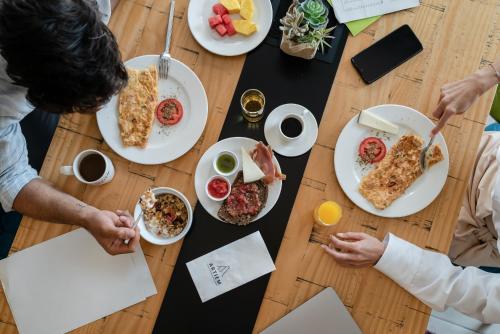 a group of people sitting around a table eating food at ARTIEM Madrid in Madrid