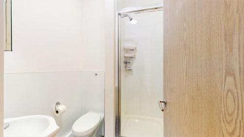 a bathroom with a toilet and a sink and a shower at Amazing Studio Apartment in London