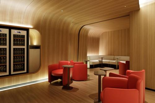 a tasting room with red chairs and a wine cellar at The Westin Miyako Kyoto in Kyoto