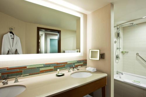 a bathroom with two sinks and a large mirror at The Westin Hilton Head Island Resort & Spa in Hilton Head Island