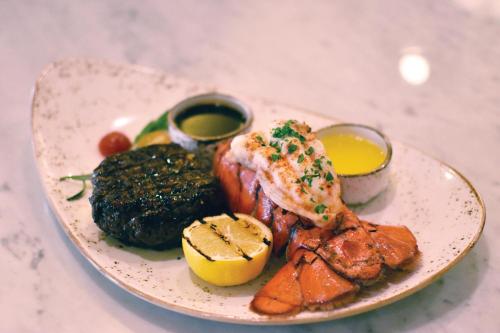 a plate of food with meat and vegetables on a table at The Westin Hilton Head Island Resort & Spa in Hilton Head Island