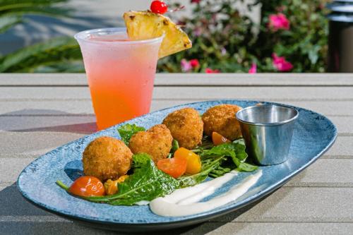 a blue plate of food with a salad and a drink at The Westin Hilton Head Island Resort & Spa in Hilton Head Island